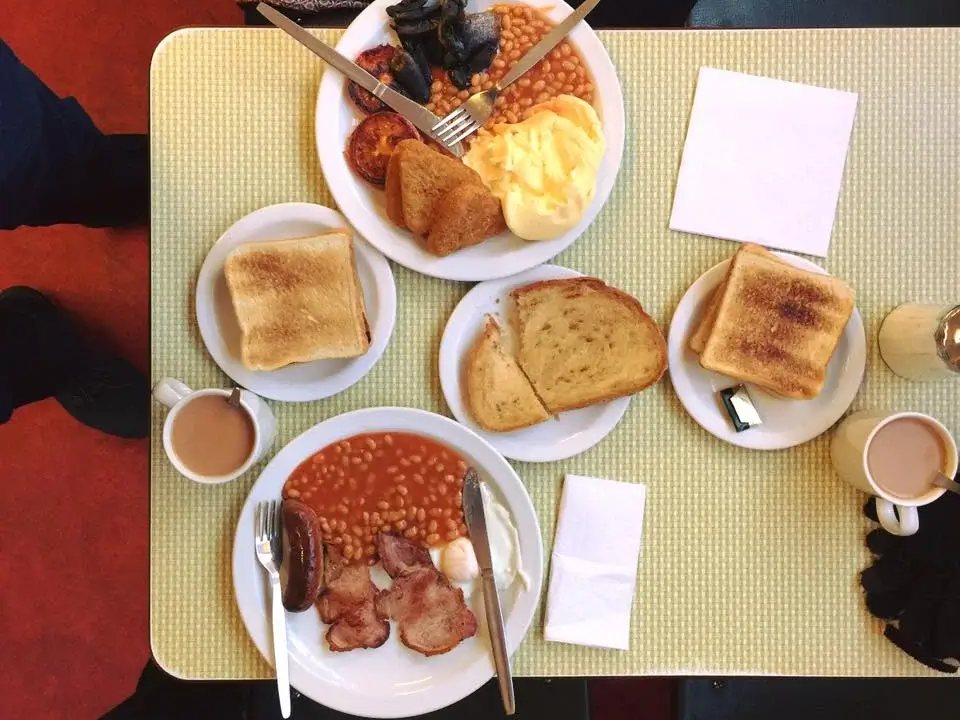 Breakfast plates, toast and tea on a Formica table at the Regency Café, London